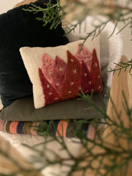 woven cushion with red trees