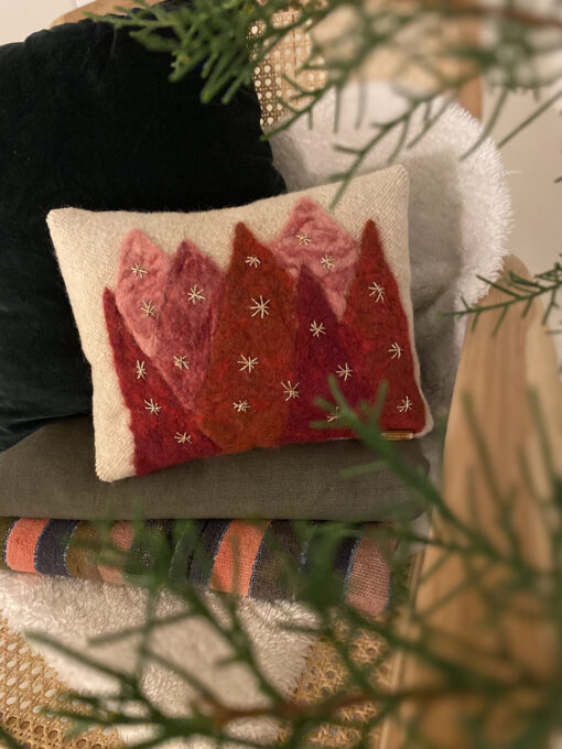 woven cushion with red trees