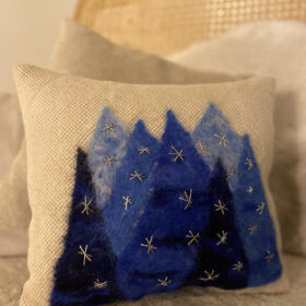 woven cushion with blue trees