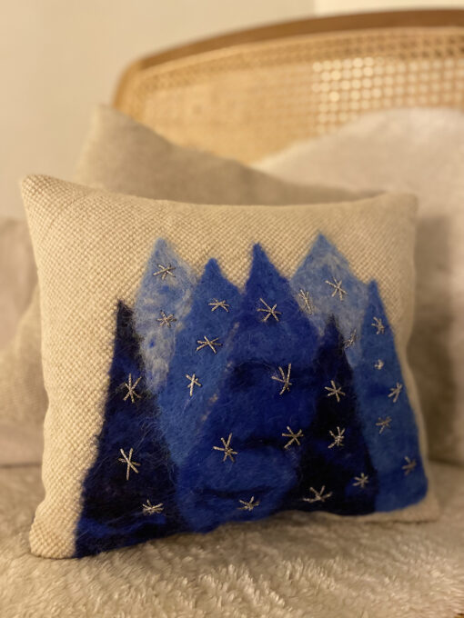 woven cushion with blue trees