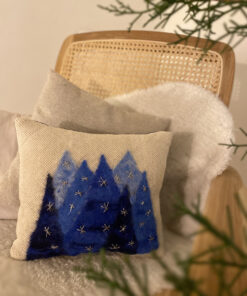 woven cushion with blue trees